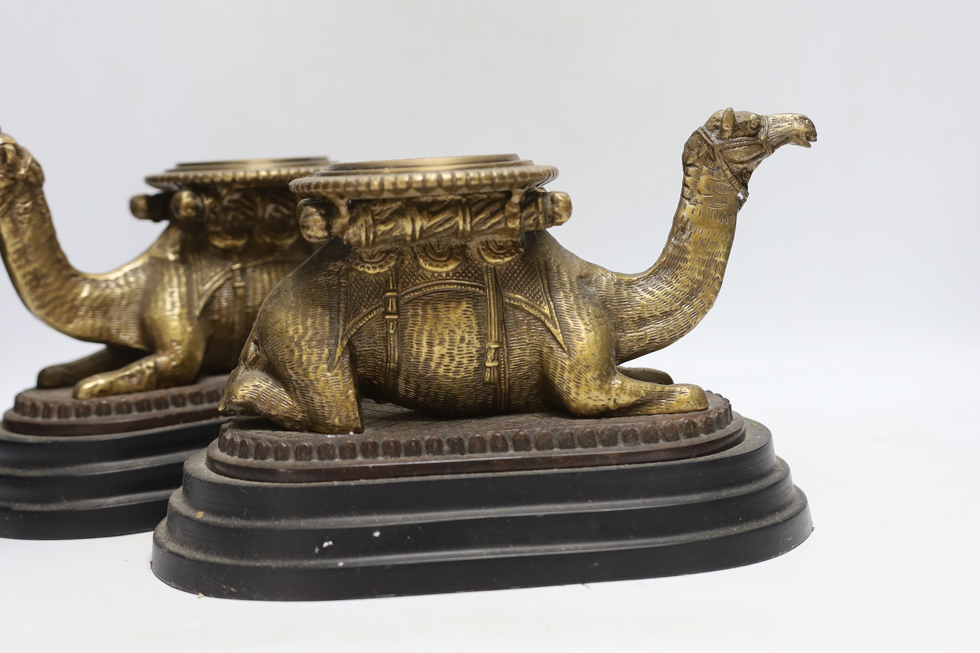 A pair of camel and obelisk side ornaments raised on tapered bases, 51cm high